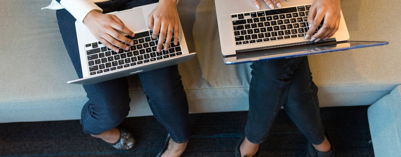 two women laptops sitting - headless commerce